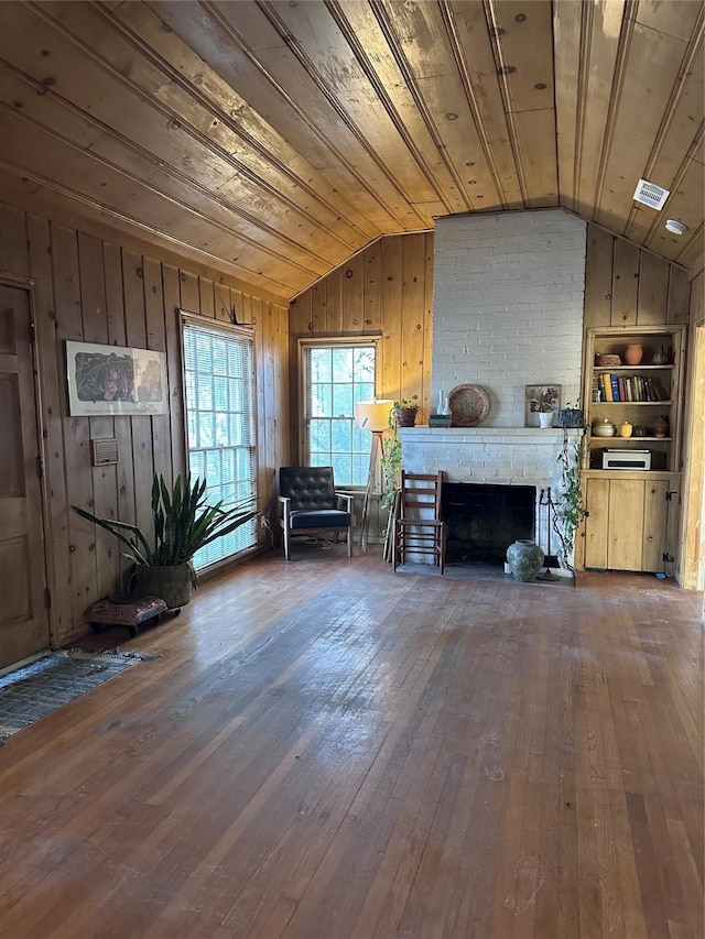 living room with dark hardwood / wood-style flooring, a brick fireplace, lofted ceiling, and wood ceiling