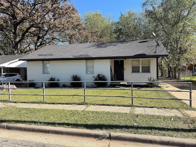 ranch-style house featuring a carport and a front lawn