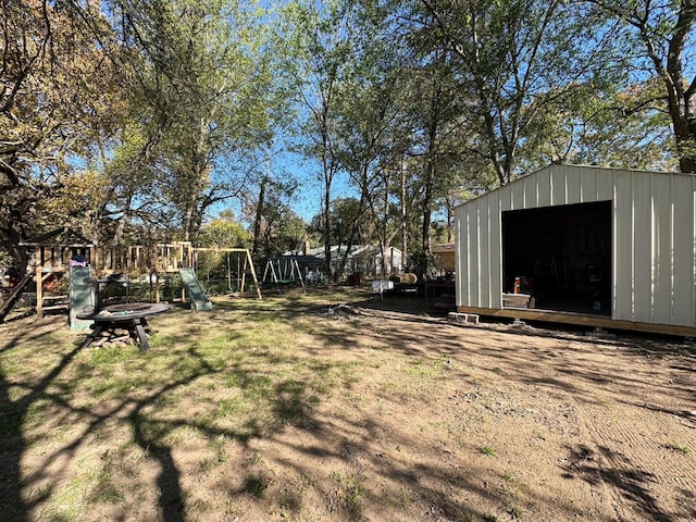 view of yard featuring a playground and a storage shed