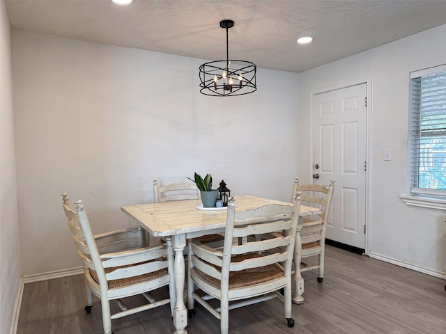 dining area featuring a notable chandelier and dark hardwood / wood-style floors