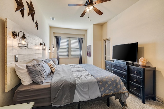 bedroom with ceiling fan and light carpet