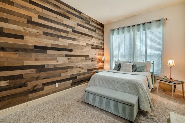 carpeted bedroom featuring wooden walls