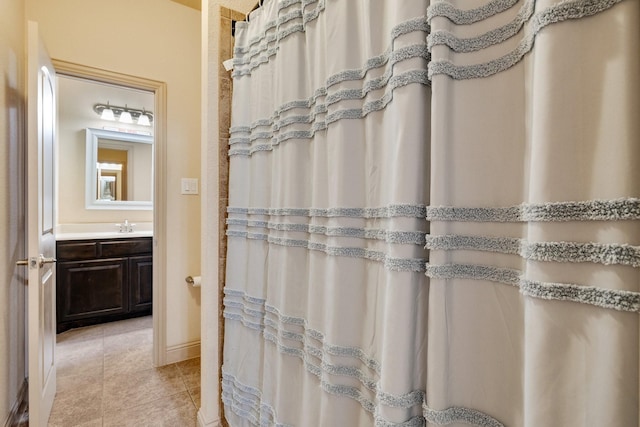 bathroom with a shower with shower curtain, vanity, and tile patterned floors