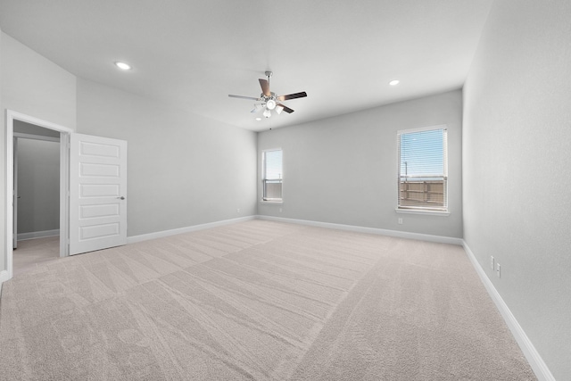 carpeted spare room featuring ceiling fan