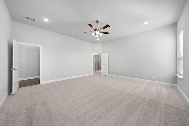 unfurnished bedroom with ceiling fan and light carpet