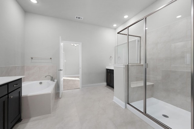 bathroom featuring separate shower and tub, tile patterned flooring, and vanity