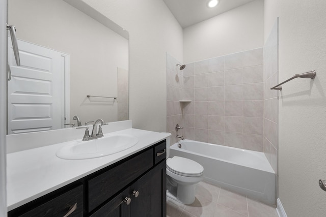 full bathroom with tile patterned flooring, vanity, toilet, and tiled shower / bath