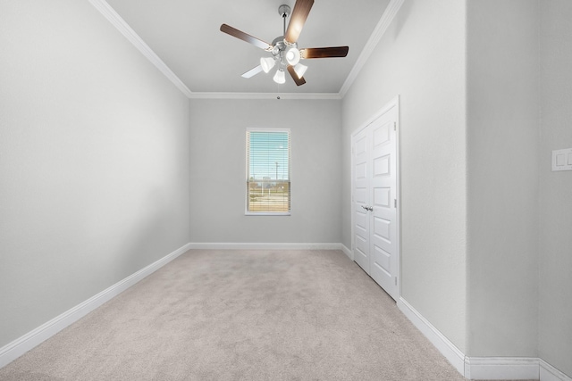 unfurnished bedroom featuring a closet, ceiling fan, crown molding, and light carpet