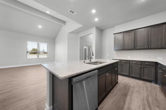 kitchen with decorative backsplash, light wood-type flooring, lofted ceiling with beams, a center island with sink, and dishwasher