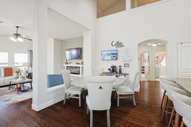 living room with dark hardwood / wood-style floors, vaulted ceiling, and ceiling fan