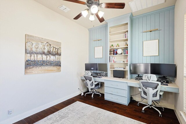 office featuring ceiling fan, built in desk, and dark wood-type flooring