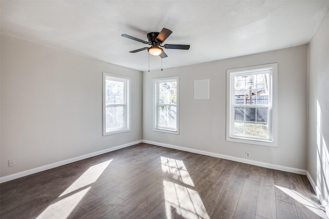 unfurnished room with dark wood finished floors, baseboards, and ceiling fan