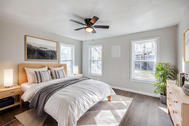 bedroom with ceiling fan and dark hardwood / wood-style floors