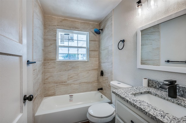 full bathroom with vanity, a textured ceiling, toilet, and tiled shower / bath