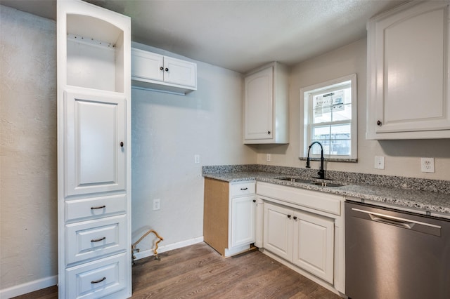 kitchen featuring light stone countertops, dishwasher, sink, dark wood-type flooring, and white cabinets