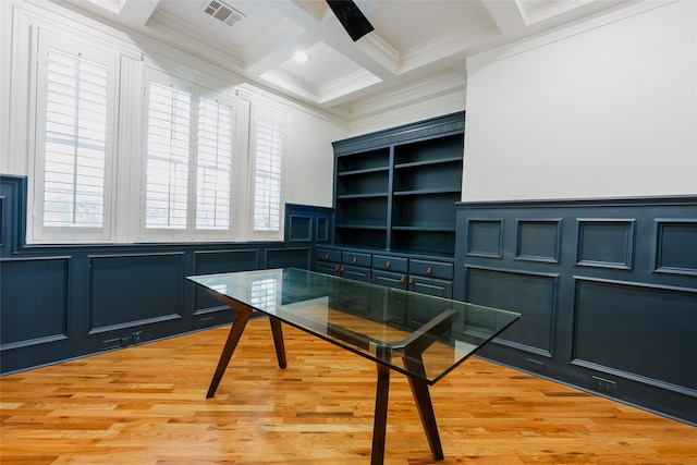 unfurnished office featuring ornamental molding, coffered ceiling, and light wood-type flooring