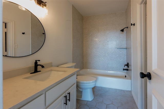 full bathroom featuring tile patterned floors, vanity, tiled shower / bath combo, and toilet