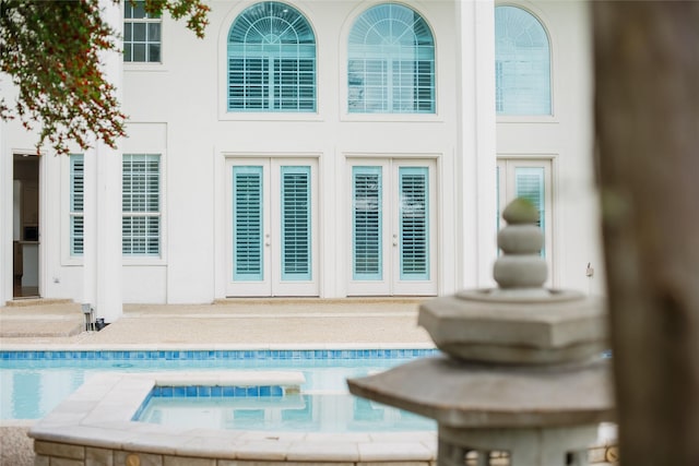 rear view of house with a pool