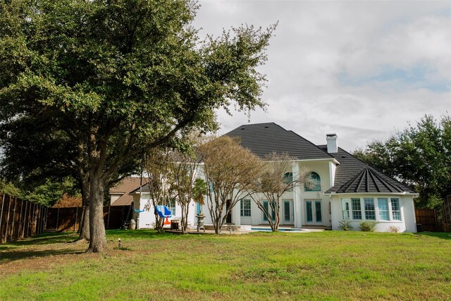 rear view of house with a lawn