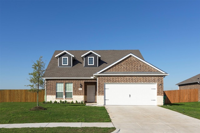 view of front of house with a garage and a front lawn