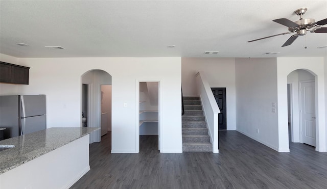 interior space featuring a textured ceiling, dark hardwood / wood-style flooring, and ceiling fan