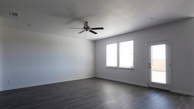 empty room featuring ceiling fan and dark hardwood / wood-style flooring