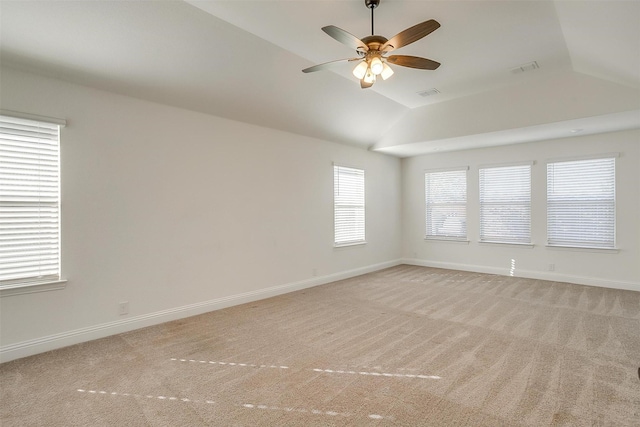 carpeted spare room featuring ceiling fan and vaulted ceiling