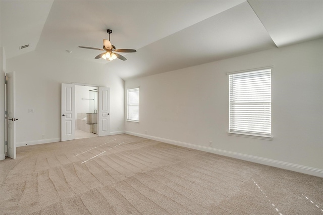 unfurnished bedroom with ceiling fan, lofted ceiling, ensuite bathroom, and light carpet