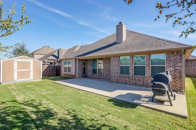 rear view of house with a patio, a storage unit, and a lawn