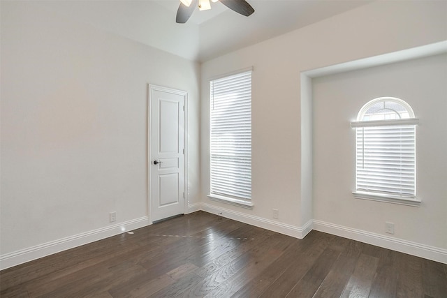 spare room featuring plenty of natural light, ceiling fan, and dark hardwood / wood-style floors