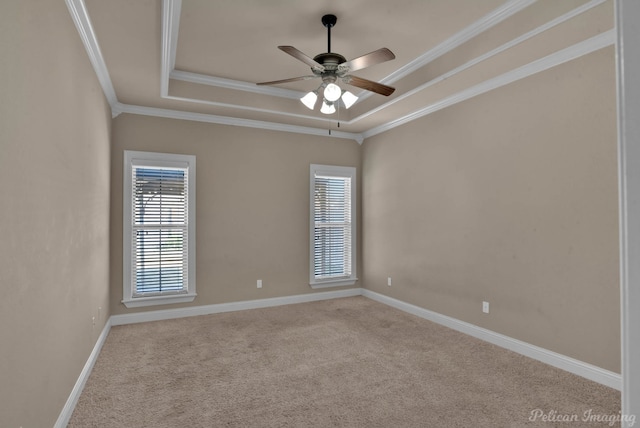 unfurnished room featuring ornamental molding, light colored carpet, ceiling fan, and a tray ceiling