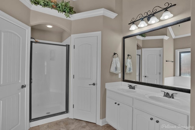 bathroom featuring tile patterned flooring, vanity, ornamental molding, and walk in shower