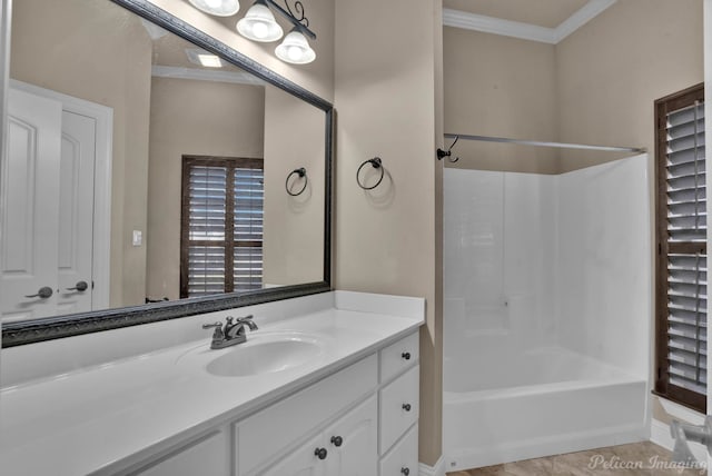 bathroom with tile patterned flooring, ornamental molding, vanity, and  shower combination