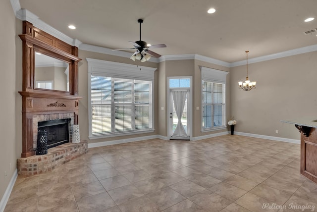 unfurnished living room with ceiling fan with notable chandelier, a healthy amount of sunlight, ornamental molding, and a fireplace