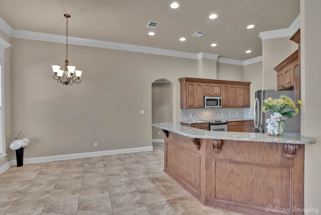 kitchen with crown molding, a breakfast bar area, stainless steel appliances, tasteful backsplash, and kitchen peninsula