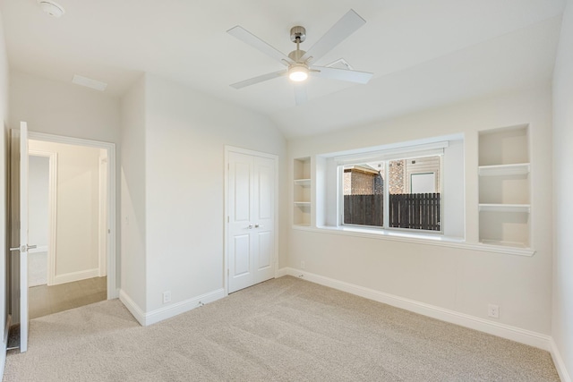 unfurnished bedroom with ceiling fan, light carpet, and a closet