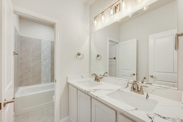 full bathroom featuring tile patterned floors, tiled shower / bath combo, toilet, and vanity