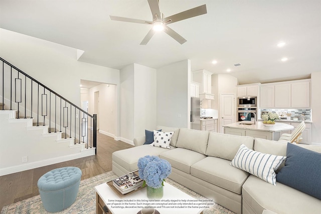 living room with ceiling fan and dark wood-type flooring