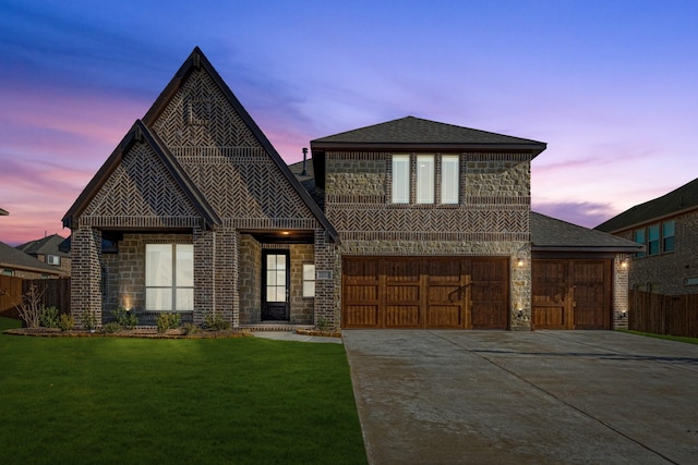 view of front of property with a lawn and a garage