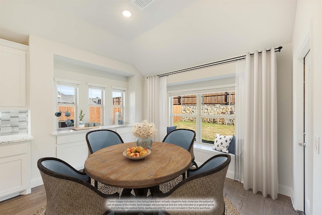 dining area featuring light hardwood / wood-style floors and lofted ceiling