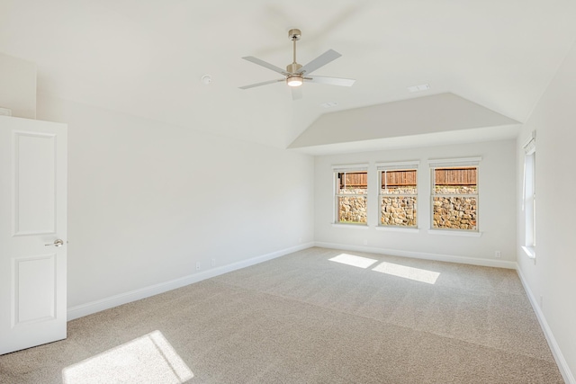 additional living space featuring ceiling fan, a healthy amount of sunlight, light carpet, and vaulted ceiling