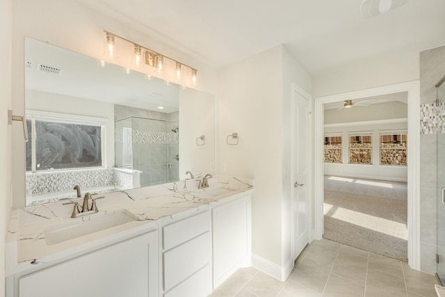 bathroom with tile patterned flooring, a healthy amount of sunlight, ceiling fan, and a shower with shower door