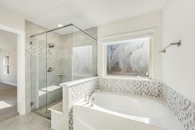 bathroom with tile patterned flooring, plus walk in shower, and plenty of natural light