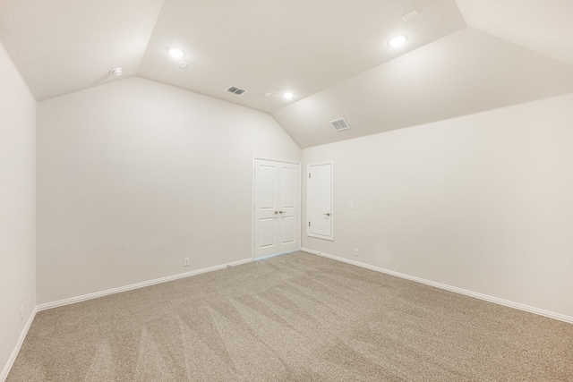 spare room with lofted ceiling and carpet floors