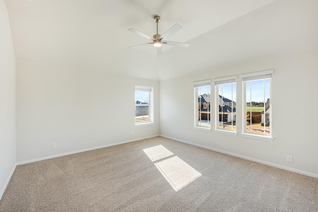 carpeted empty room with ceiling fan and vaulted ceiling