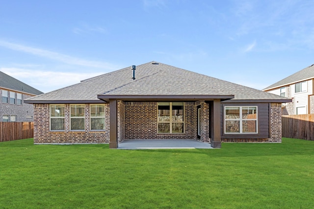 rear view of property with a lawn and a patio