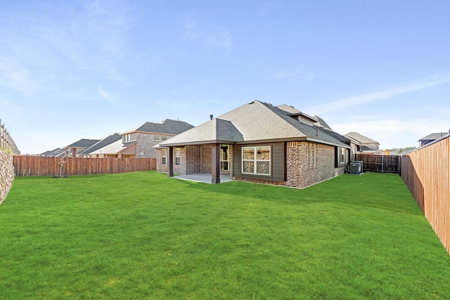 back of house with a lawn, central AC, and a patio