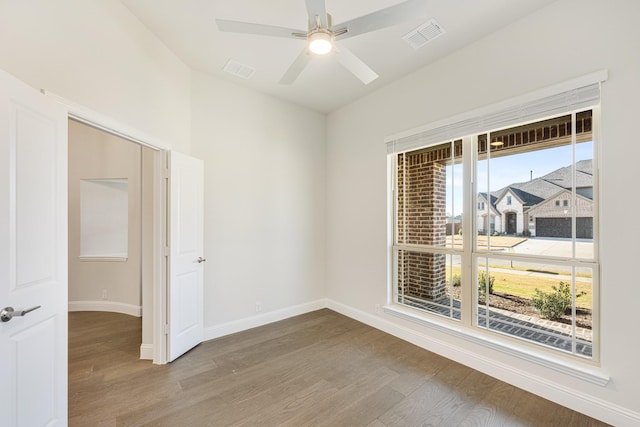 spare room with wood-type flooring and ceiling fan