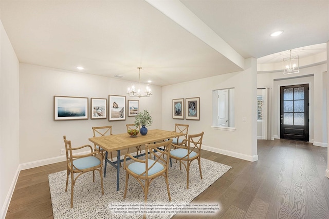 dining room featuring an inviting chandelier and dark wood-type flooring