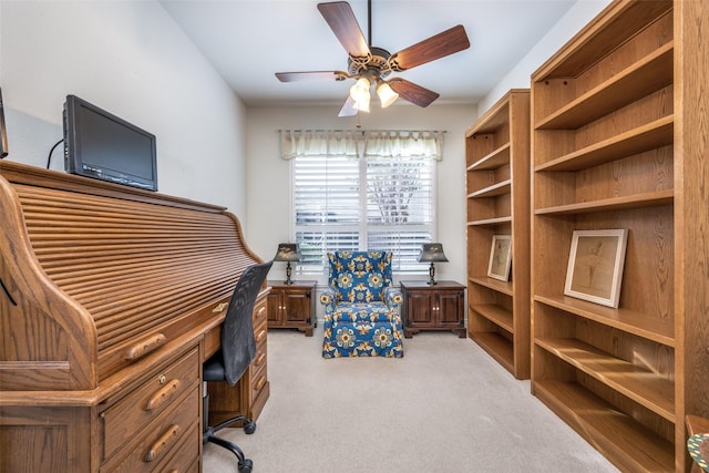 office space featuring light carpet and ceiling fan